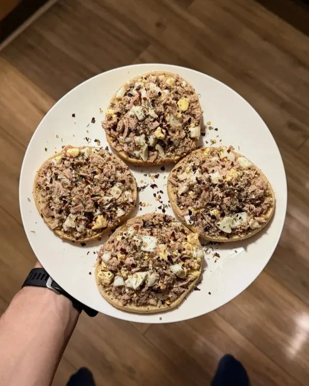 Toasted muffin halves with a tuna and egg topping