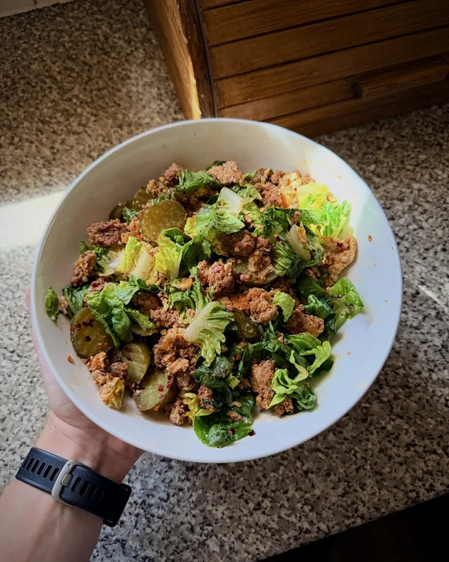 A mince and green salad bowl held in the kitchen